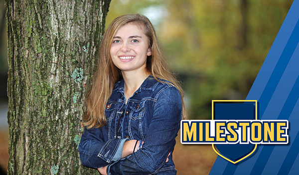 amy smith smiling next to tree.