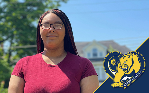 Mount St. Joseph University liberal arts student evelynn smiling outside with blue sky and clouds