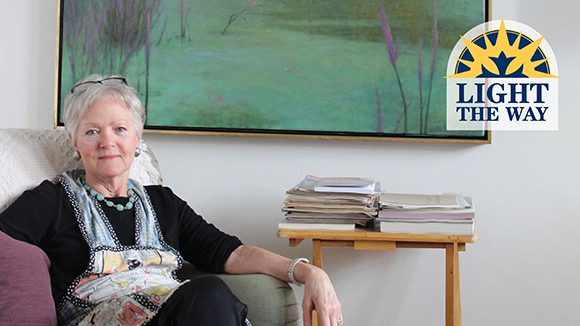 kay hurley next to a landscape painting she painted