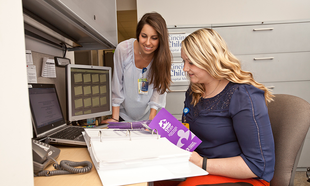 two women working at desk on project offsite