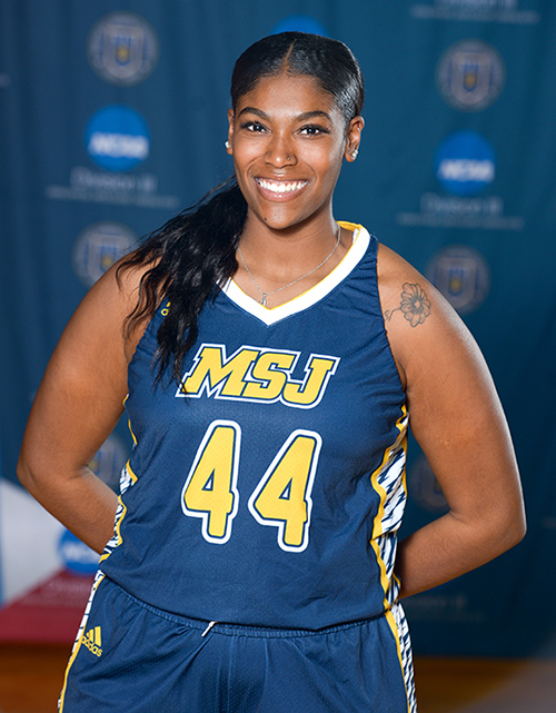 female student in Mount basketball uniform