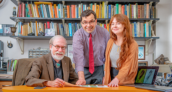 three MSJ employees at table smiling 