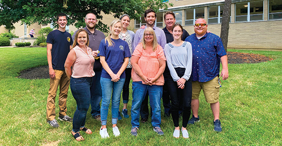 msj marketing group standing in group photo in quad smiling