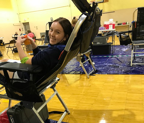 student sitting to get blood drawn