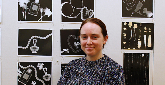 Mount St. Joseph University professor Emily Wiethorn in front of her photography.