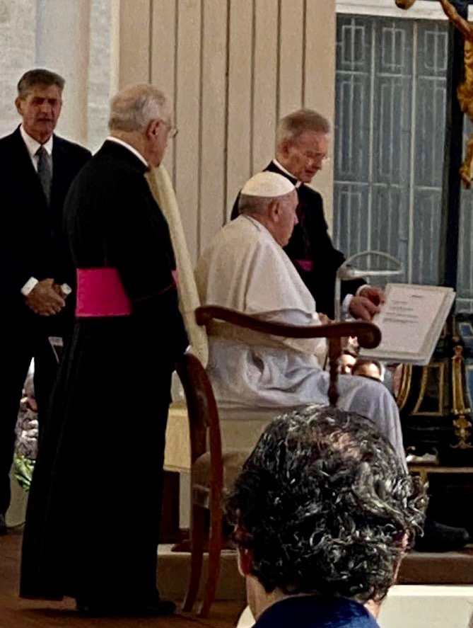 Pope Francis with clergymen at Vatican.