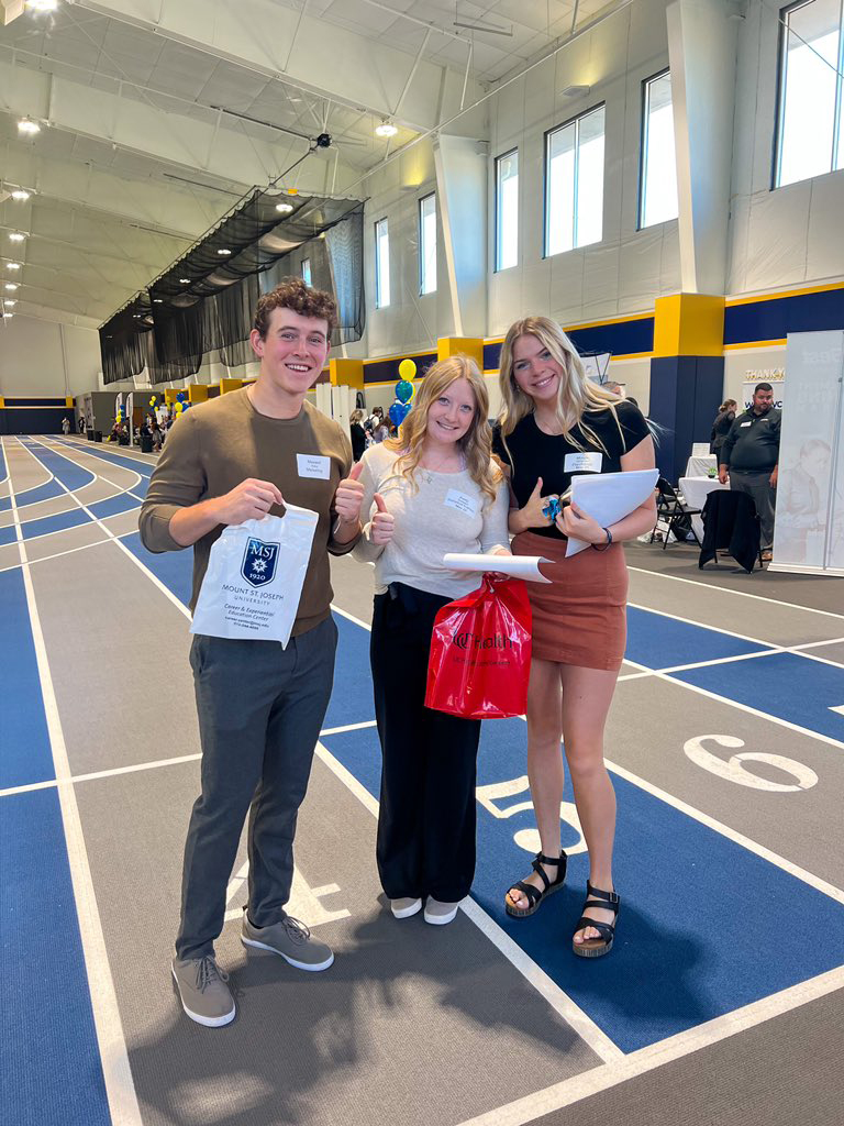 students side by side in centennial field house for career fair