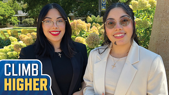 paola and valeria guillermo in msj quad in front of St. Joseph Statue smiling.