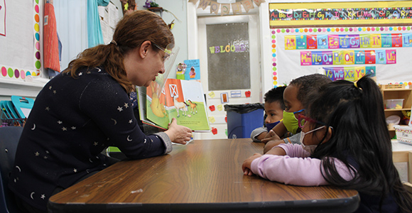 Dr. Amy Murdoch reading book to reading science class children.