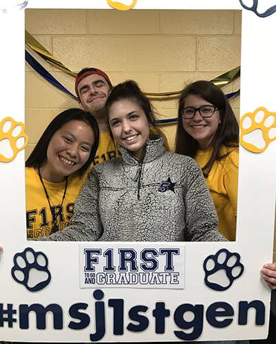 Mount St. Joseph University first generation students holding poster.