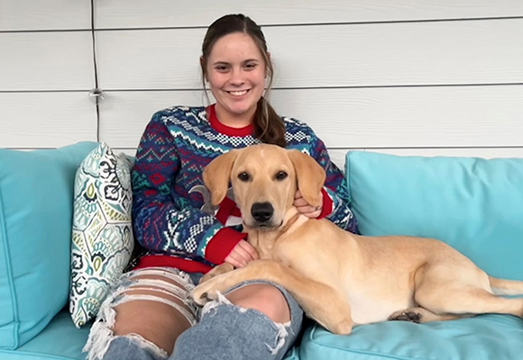 msj student holding golden retriever puppy.