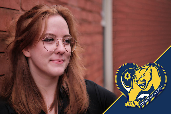 Mount St. Joseph university alumna hope krieger looking into distance next to brick wall