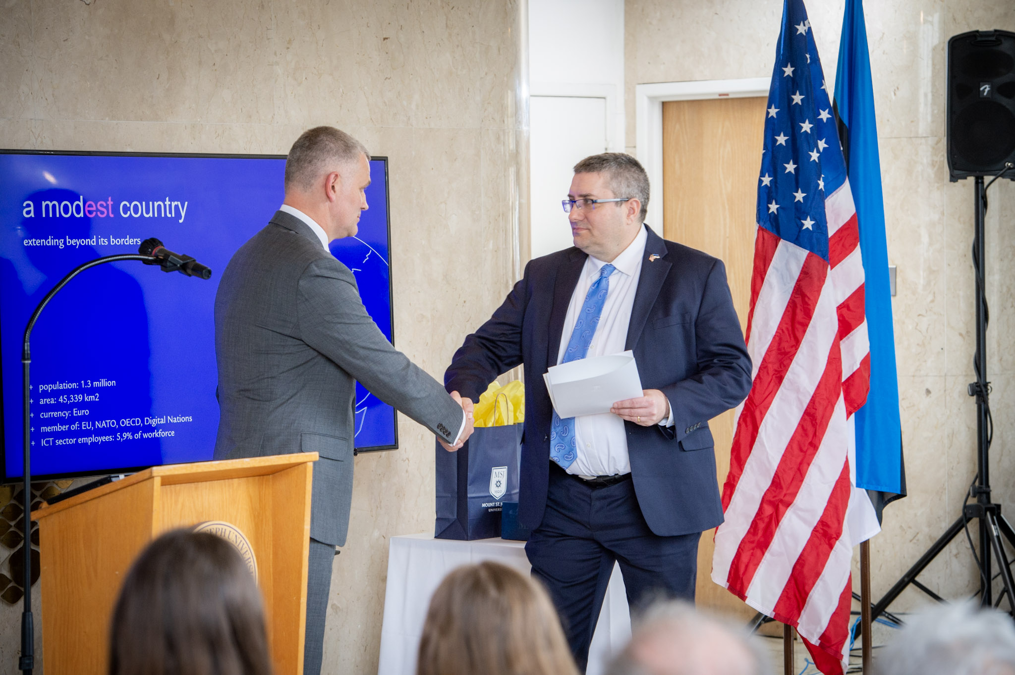 charles shaking ambassador's hand