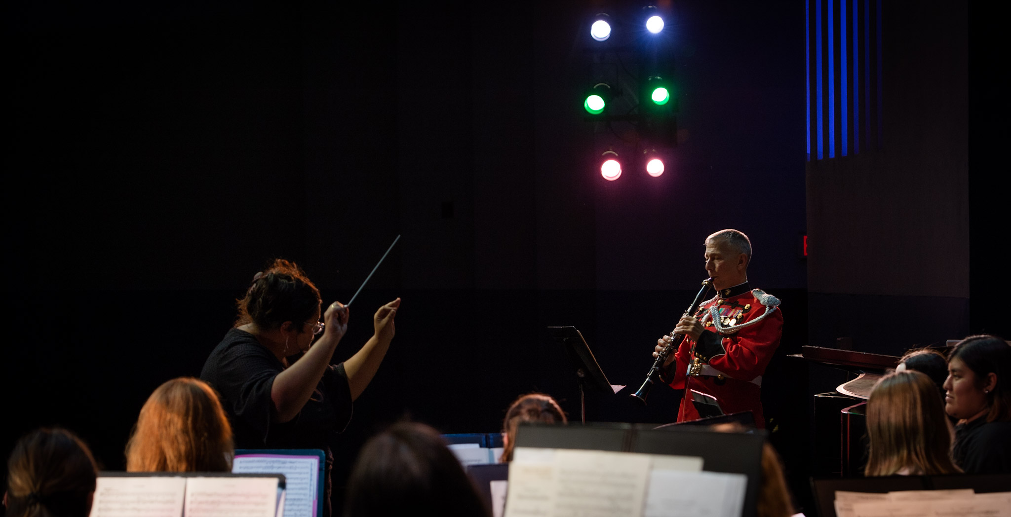 MSJ concert band playing instruments on University Theatre stage.